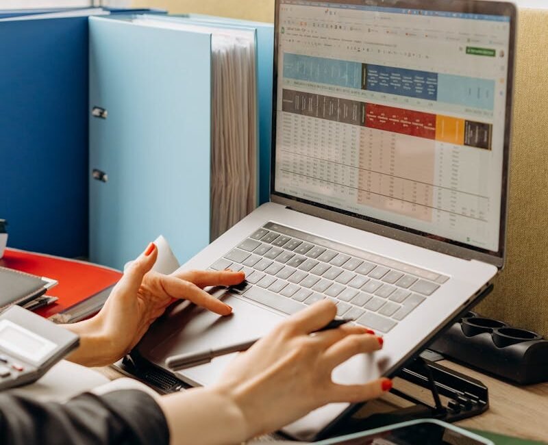 Business workspace with folders and laptop showing analytics screen. Ideal for tech and work themes.